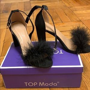 Black heel with fluff on front strap